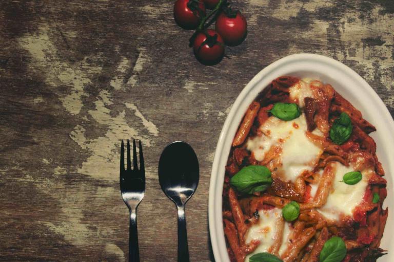 Mouth watering vegetarian pasta bake with rich tomato sauce and cheese toppings